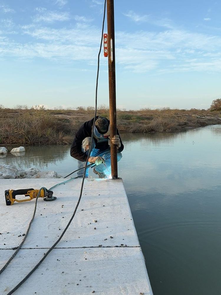 Welding on a concrete dock over water
