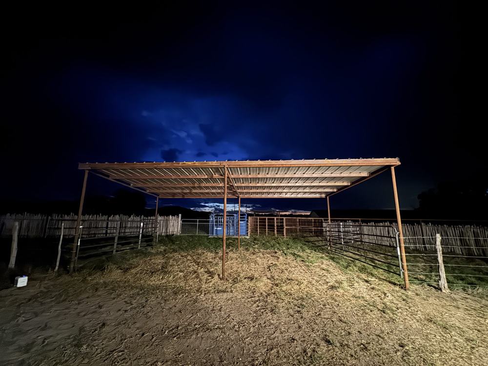 Pipe-frame shelter at night