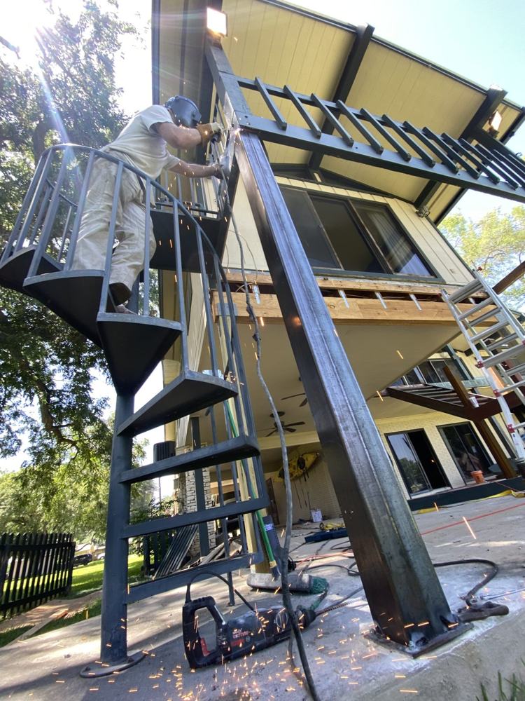 Spiral steel staircase against a house
