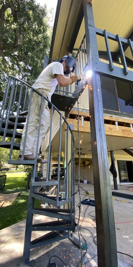 Luke welding a custom steel staircase