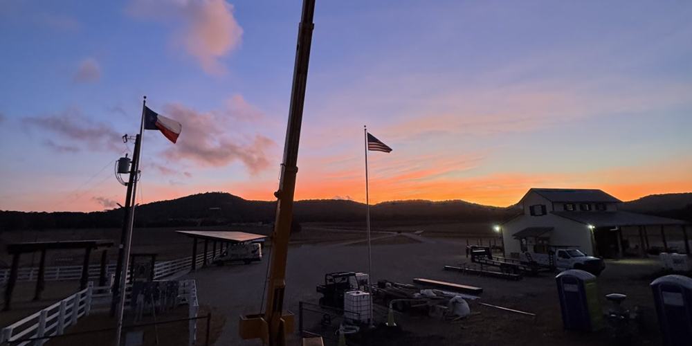 Crane boom at dusk on a job site